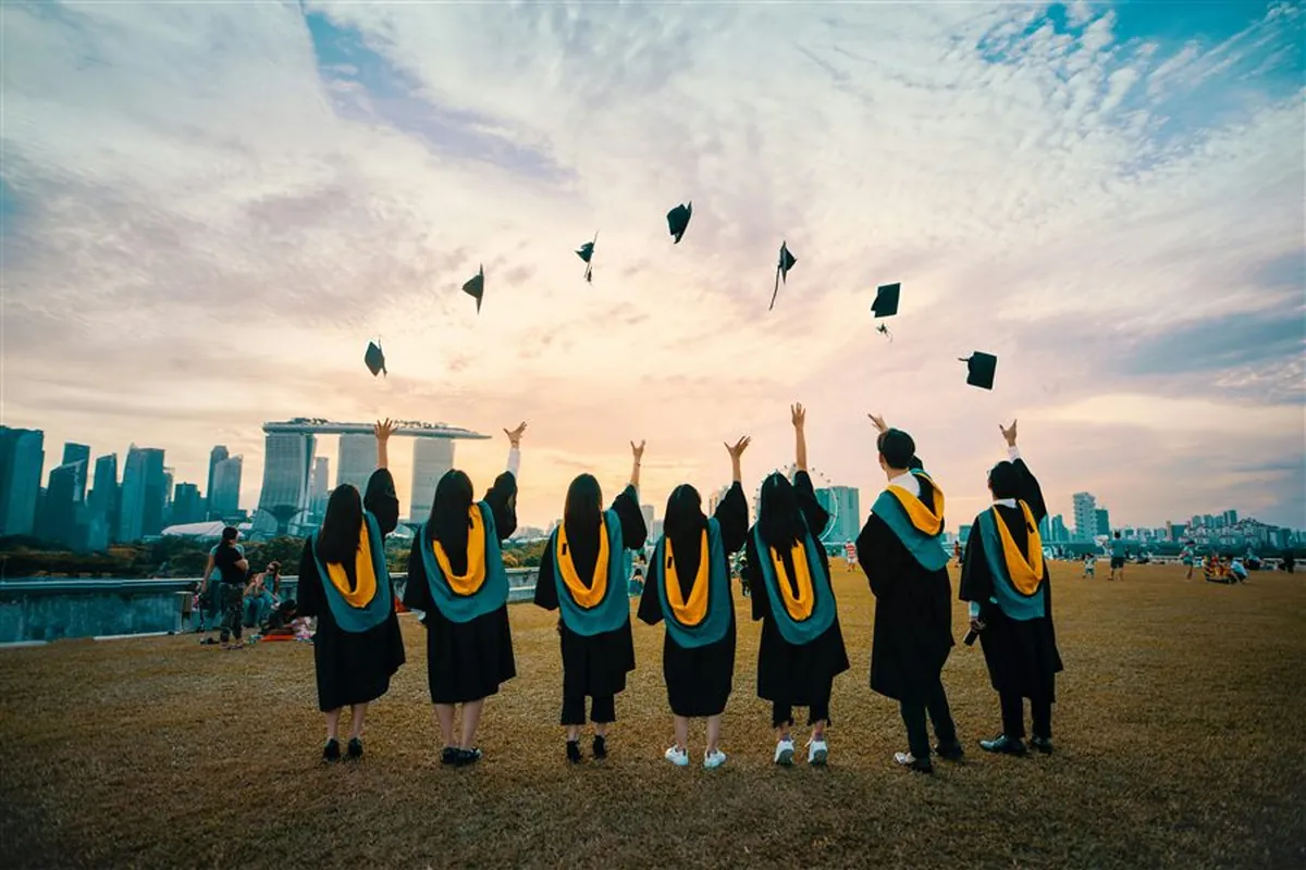 Graduates throwing their caps into the air